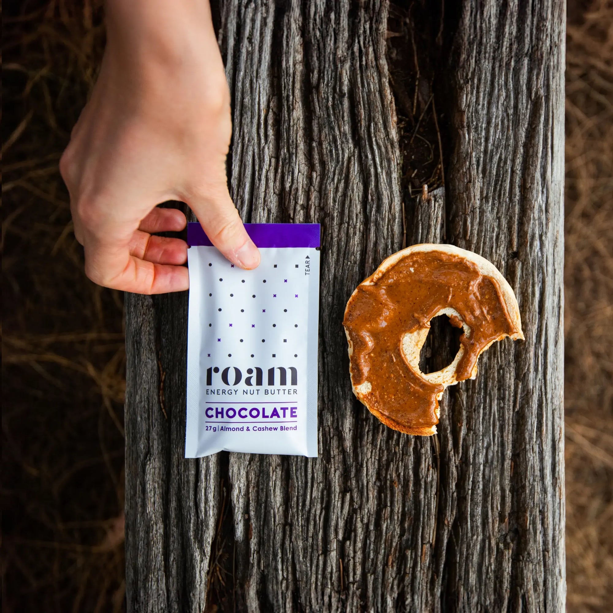 Roam Chocolate Energy Nut Butter with bagel in the forest