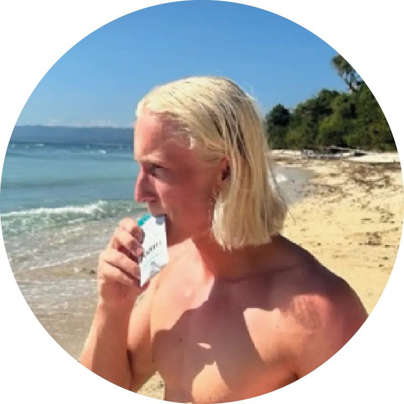 A surfer eating Roam Energy Nut butter at the beach